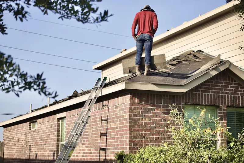 Professional roofer working on a residential roof in Scurry